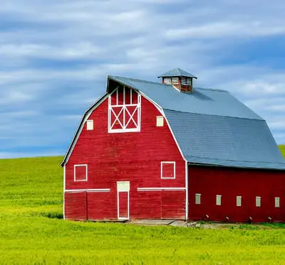 A red barn in a green field.