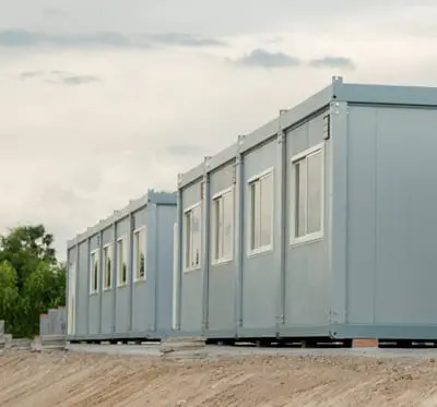 SEO optimized portable office containers lined up on a construction site.
