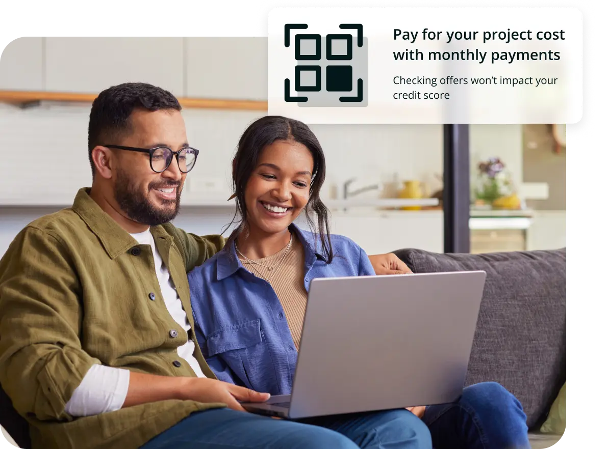 A couple is starting a loan application on a computer.